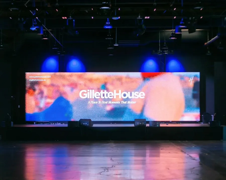 Main auditorium stage with a large LED screen reading Gillette House