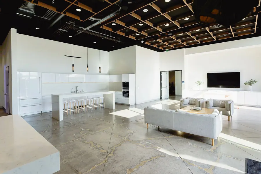 Bright indoor lounge with an open kitchen and bar seating
