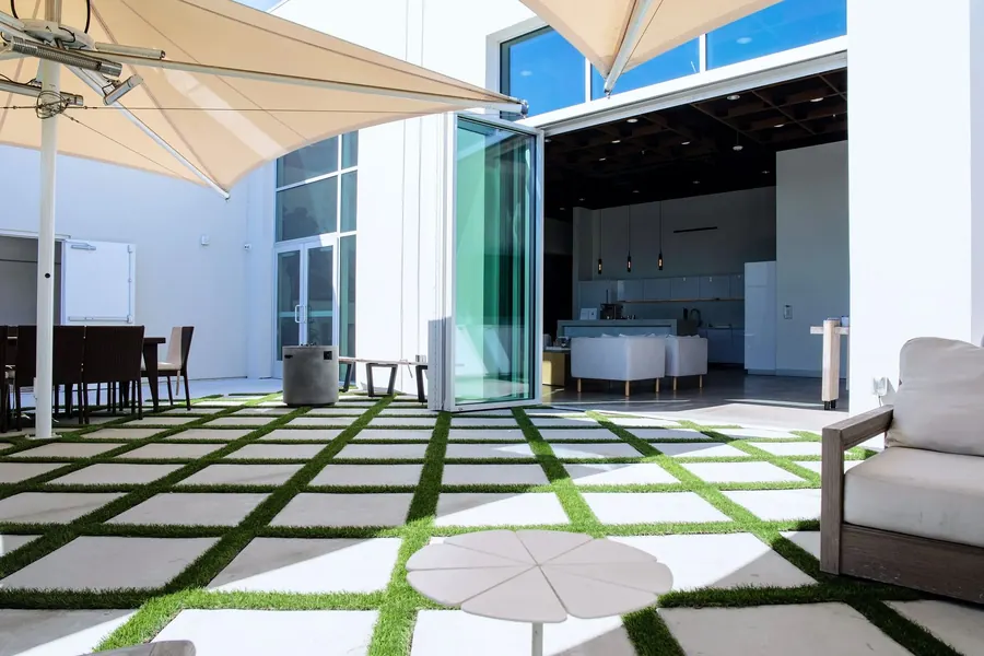 Outdoor courtyard with lounge seating and a shade sail